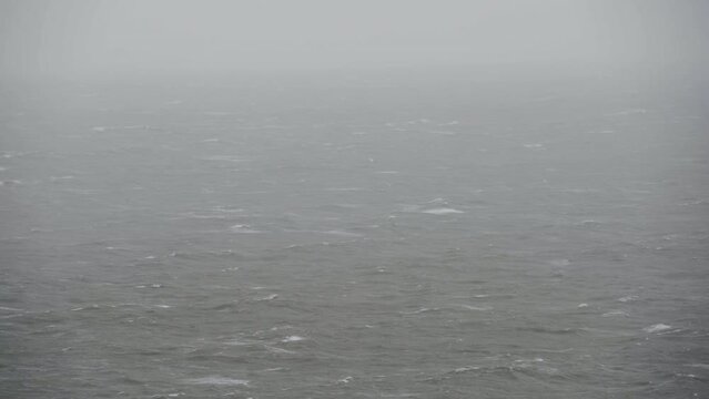 Distant views of stormy seas with rain