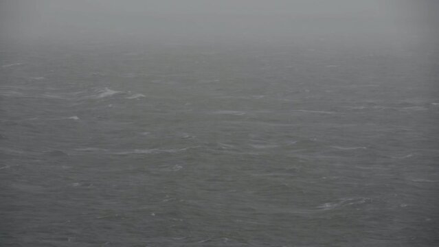 Waves rolling across screen on stormy rainy day