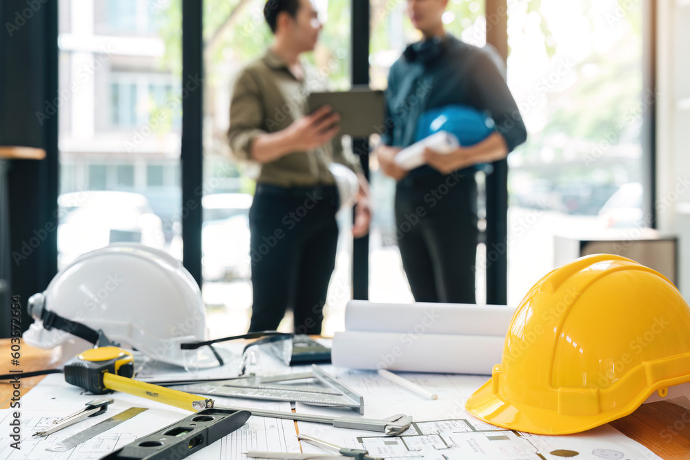 Wall mural engineer teams meeting working together holding worker helmets on construction site in modern city.a