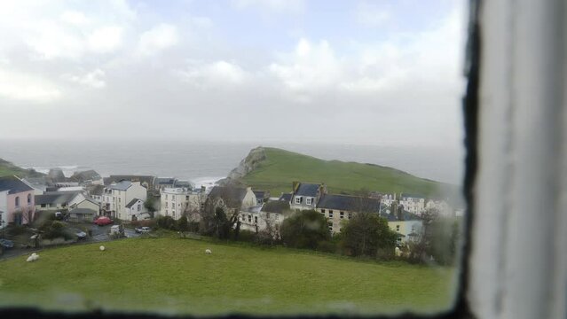 Bedroom window view of Ilfracombe, England on stormy spring day