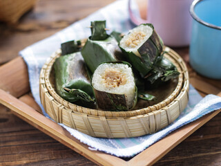 Lemper Bakar. Lemper is a traditional Indonesian snack made of glutinous rice and filled with chicken meat and wrapped in banana leaves. Selective focus