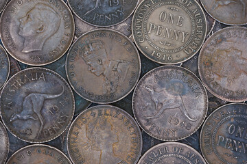 Flat top view montage of old bronze Australian penny coins filling the frame soft lighting 