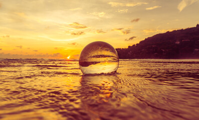 Magnificent sky above the crystal ball on the beach..The beautiful reflection of the sky above the crystal ball on the wet sand beach..Unique and creative travel and nature idea