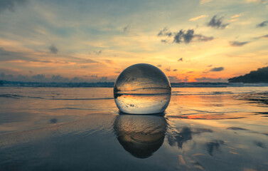 Magnificent sky above the crystal ball on the beach..The beautiful reflection of the sky above the...