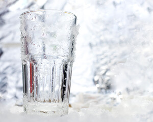 Clear glass. There are no items in it. with ice crystals The back is silver, like a large ice cube