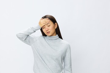 Asian woman holding her hand to her head for severe headache, migraine white background