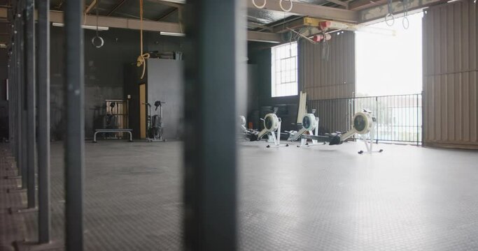 General view of empty fitness room at gym with exercise equipment, in slow motion