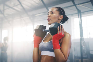 Focus, sweating and dumbbell with woman in gym for training, weightlifting and workout. Health,...