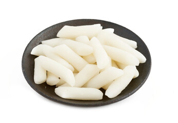 Tteok or Korean Rice Cakes in plate isolated on white background. pile of Tteok or Korean Rice Cakes in dish isolated on white background. Tteok Korean Rice Cakes                      