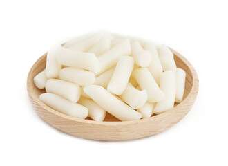 Tteok or Korean Rice Cakes in wooden plate isolated on white background. pile of Tteok or Korean Rice Cakes in wooden dish isolated on white background. Tteok Korean Rice Cakes                      