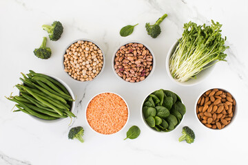 Legumes, spinach on a light background. Vegetable protein. Vegetarianism, healthy eating.