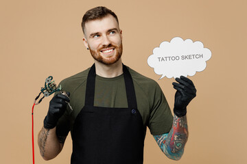 Minded tattooer man wear t-shirt apron hold blank Say cloud, speech bubble with tattoo sketch text...