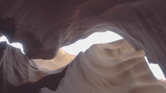 A low shot inside the Antilope Canyon in Arizona USA America looking through the rocks into the bright sky LOG