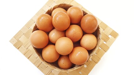 Eggs chicken fresh in wooden basket isolated on white background