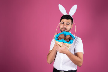 Young attractive student dressed as a rabbit on Easter holiday. Happy man.	