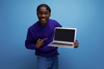 freelancer african young brunette man with dreadlocks with laptop