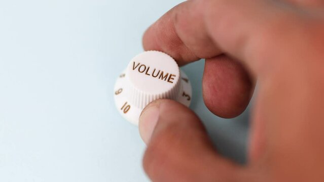 Close up of a black male hand turning volume level