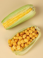 Fresh corn and popcorn on the table, close-up, top view
