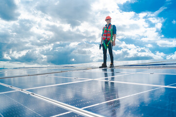 Male professional engineer installing solar photovoltaic panel system, Electrician mounting blue solar module technology on power industrial factory roof, Alternative energy ecological technician job