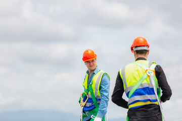 Technician engineer planning to setting solar panel on the roof of the building to work at full efficiency, Using solar cells for energy saving to save and protect environment. Renewable energy