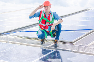 Male professional engineer installing solar photovoltaic panel system, Electrician mounting blue solar module technology on power industrial factory roof, Alternative energy ecological technician job