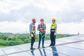 Technician engineer service meeting and checking solar cell on rooftop of industrial factory. Inspection worker repair solar cell panels. Clean Renewable energy, Ecology and alternative power concept