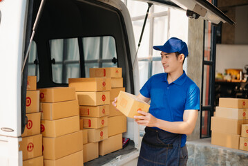 Smiling delivery man standing in front of his van with Holding Box and tablet delivery home and shipping