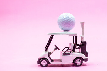 Golf cart with ball on the roof on pink background for golfer 