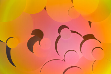 Bright pink and yellow abstract pattern of different circles fly in radial gradient with shadows. Abstract background, texture in summer sunset tropical color.