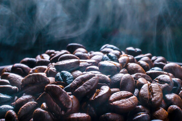 Coffee beans roasting with smoke, selective focus, and soft focus.