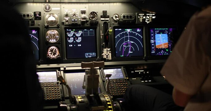 Rear view of the pilots and aircraft control panel instruments inside the cockpit during the takeoff of the aircraft. Flight control concept. Airplane flight simulation.