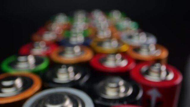 Detailed macro shot of spent alkaline batteries, typically found in TV remote controls and flashlights. Captured against a black backdrop.
