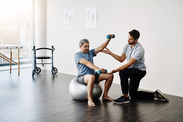 Dumbbells, physiotherapy and balance with doctor and old man for rehabilitation, training and...