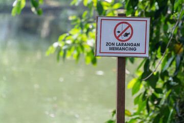 English translation for Malay wordings is "Do not fishing" sign which is located beside the lake.