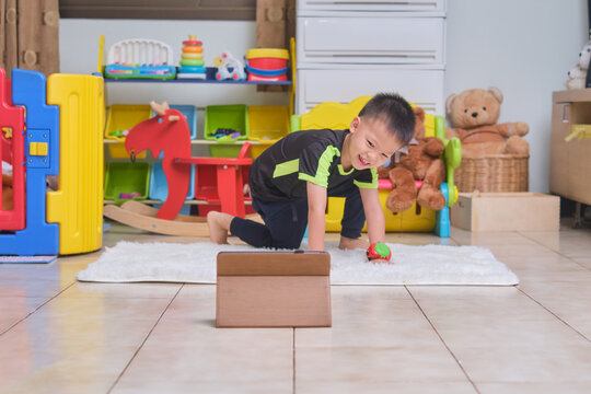 Little Asian 5 Years Old Toddler Boy Practices Yoga And Meditating With Online Training On Tablet Computer At Home, Beginner Meditation, Breathing Exercise For Kids, Healthy Lifestyle Concept