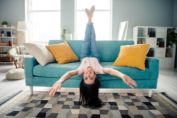 Photo of single lady toothy smiling laughing feel carefree fooling upside down in modern interior...