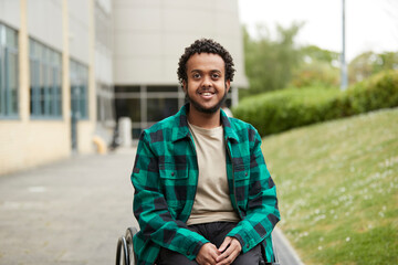 Portrait of smiling young man in wheelchair