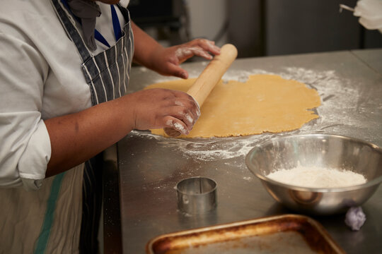 Teenage cook working in kitchen