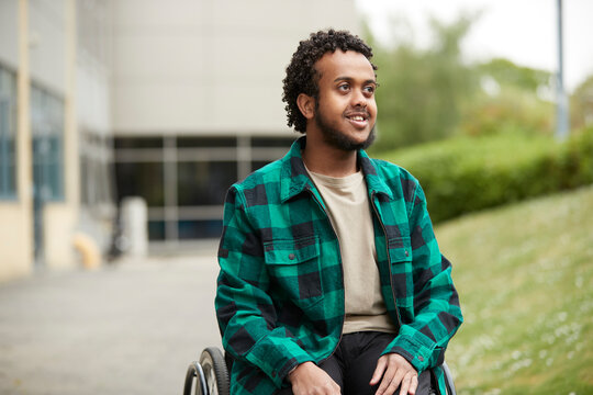 Smiling young man in wheelchair
