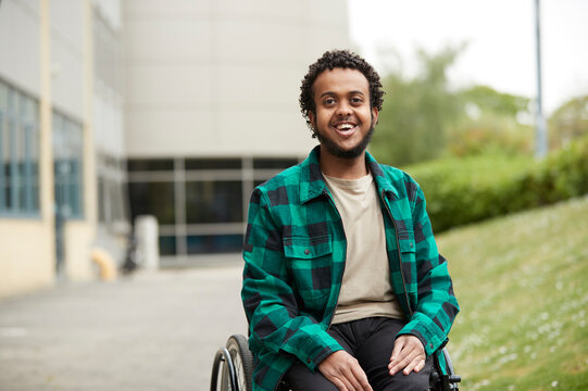 Portrait of smiling young man in wheelchair