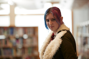 Portrait of student with colorful hair in library