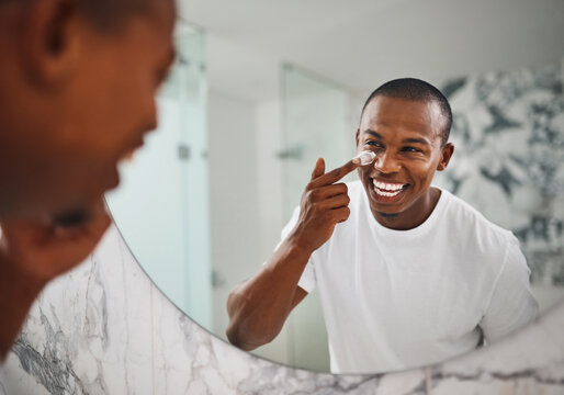 Happy, skincare and mirror with black man in bathroom for beauty, morning and grooming. Cleaning, hygiene and self care with reflection of person and cream at home for facial, natural and wellness