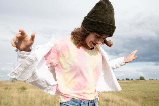 Smiling girl frolicking in field