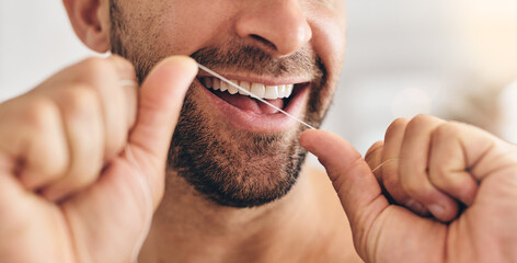 Closeup, face and man flossing teeth at home for healthy dental wellness, plaque and gingivitis....