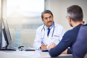 Fototapeta na wymiar Medical, discussion and doctor in a consultation with a patient analyzing diagnosis in the clinic. Professional, conversation and mature male healthcare worker talking to man in the medicare hospital