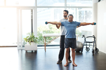 Training, physiotherapy and stretching with doctor and patient for rehabilitation, dumbbells and help. Healthcare, wellness and healing with old man and expert for consulting, muscle and exercise