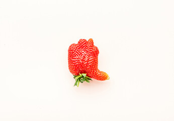 Unusual strawberry in the shape of hand with thumb up similar the like sign, beige background, top...