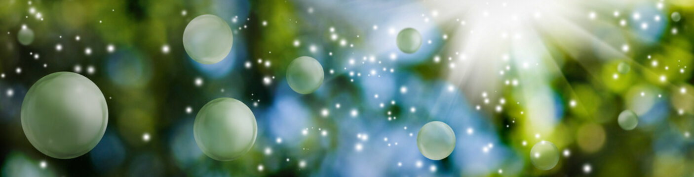 image of green blurred background with bokeh, bright flash of light and flying balls. Horizontal banner