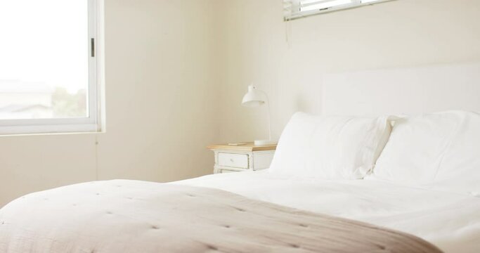 General view of bedroom with pillows on double bed, slow motion