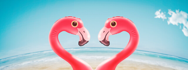 Romantic inflatable flamingos at the beach